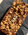 extra large Salted Caramilk caramel slice with "dad" written in white chocolate