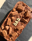 extra large Tim Tim caramel slice with "dad" written in white chocolate