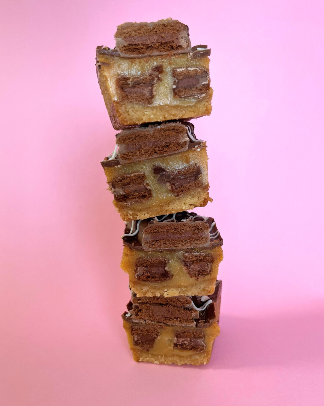 Baked_Tim_Tam_Caramel_Slice Halved in a pink background