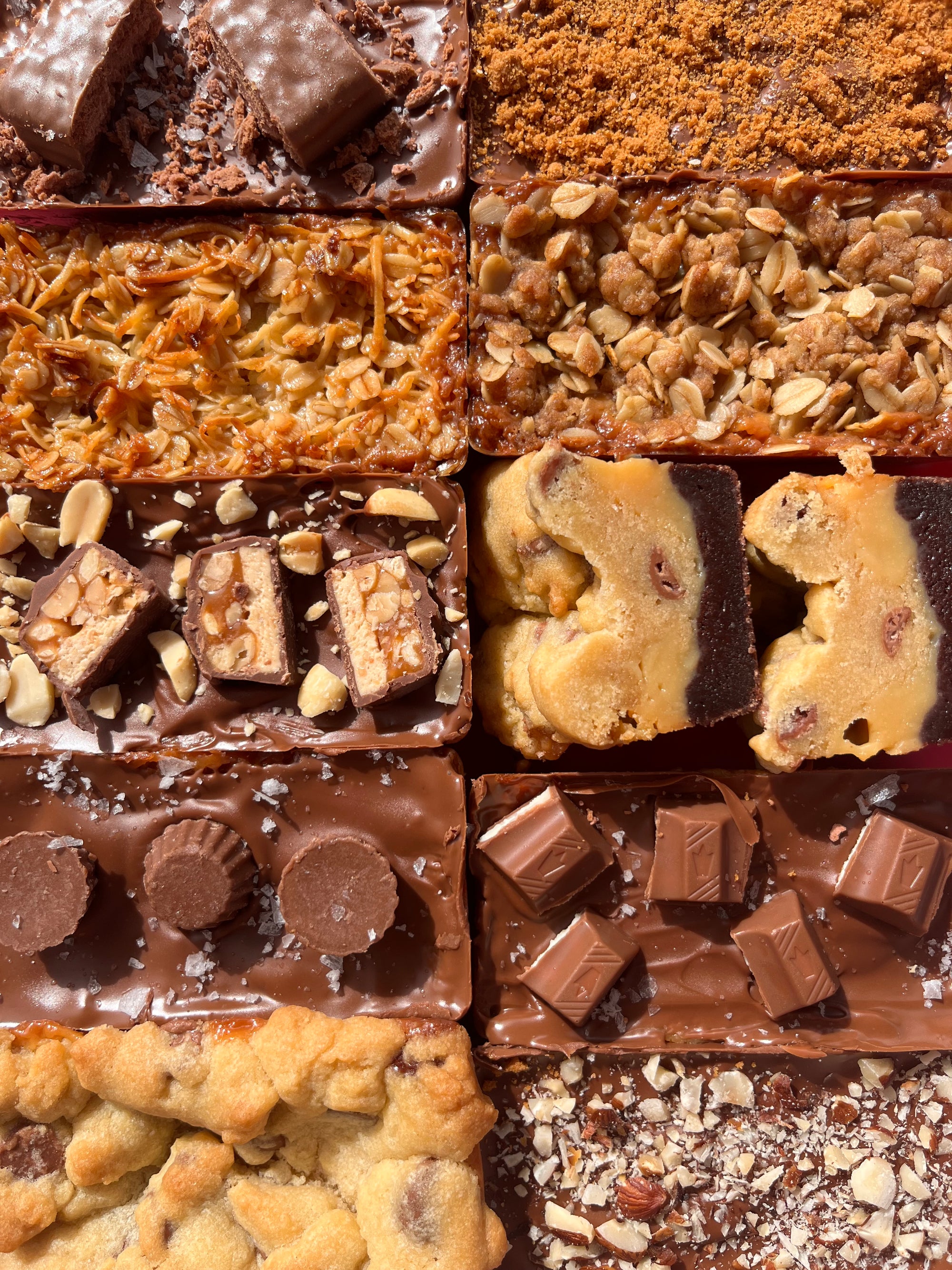 Assorted caramel slices with different toppings arranged in a grid. Tim tam, kinder, cookie, snickers, brownie